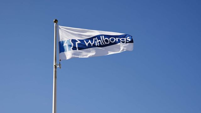 A white flag with the blue Wihlborg's logo.