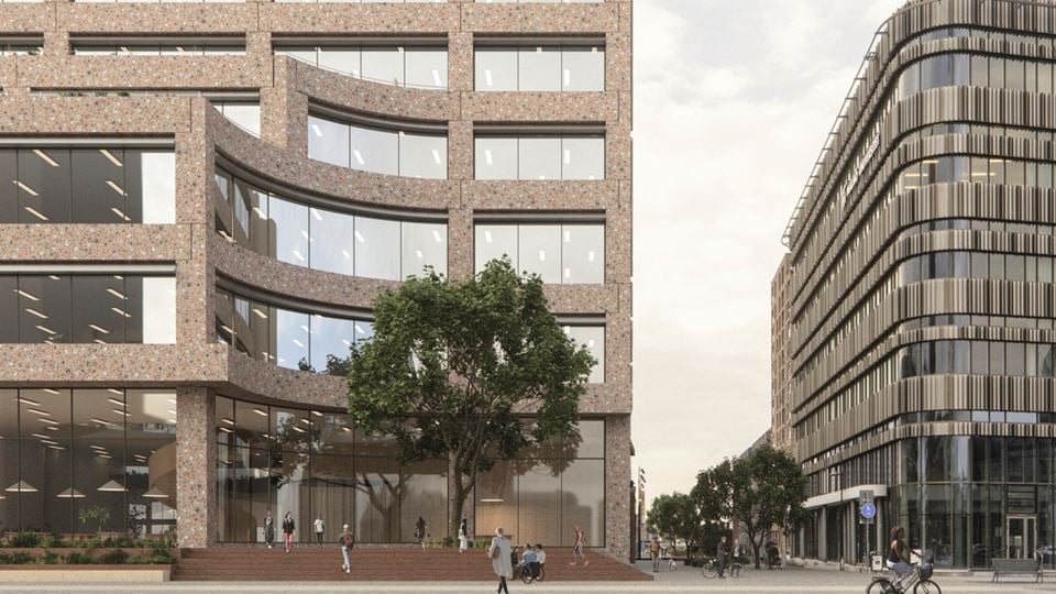 En visionsbild som visar den färdiga byggnaden i universitetsområdet. Personer går utanför.