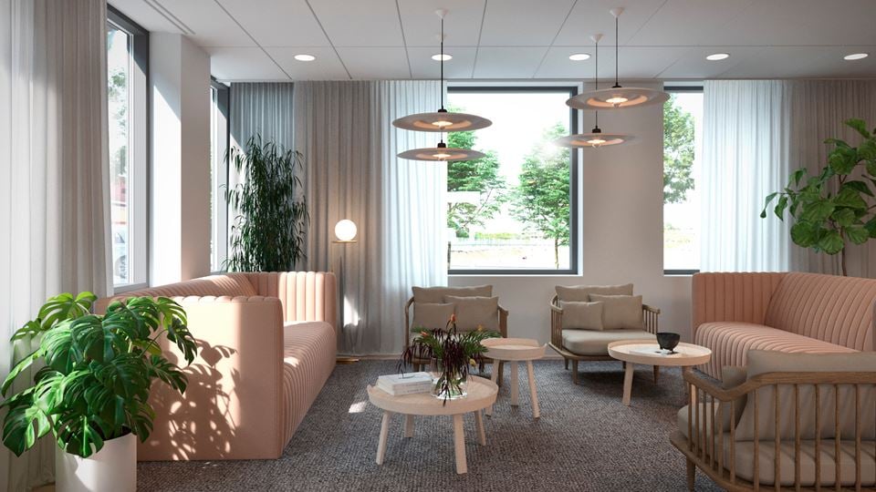 Meeting lounge with sofas and large windows.