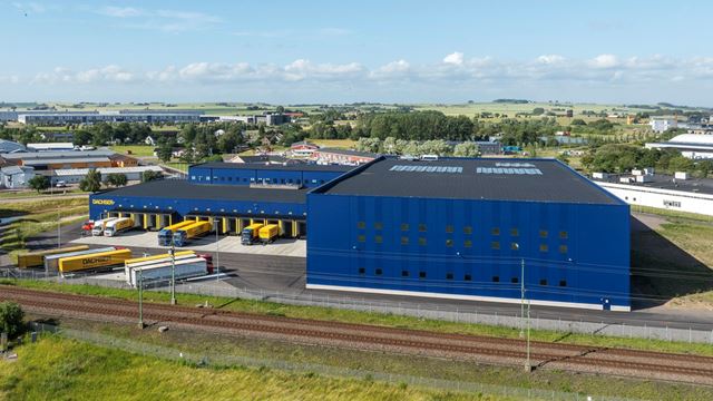 Bilden visar fastigheten snett från ovan. Visar baksidan av fastigheten med lastportar och lastbilar