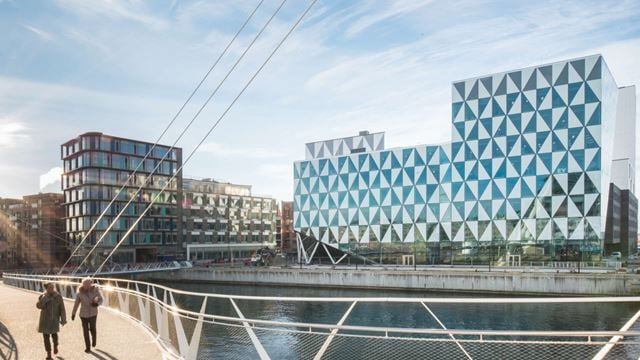 Two people walking accross the bridge from Prisma in Helsingborg.